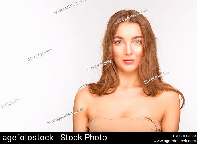 Portrait of cheerful beautiful model lady posing for photographer in studio. Pretty woman with red lips over white background