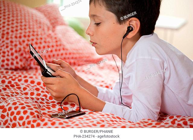 10 years old boy playing with video game console