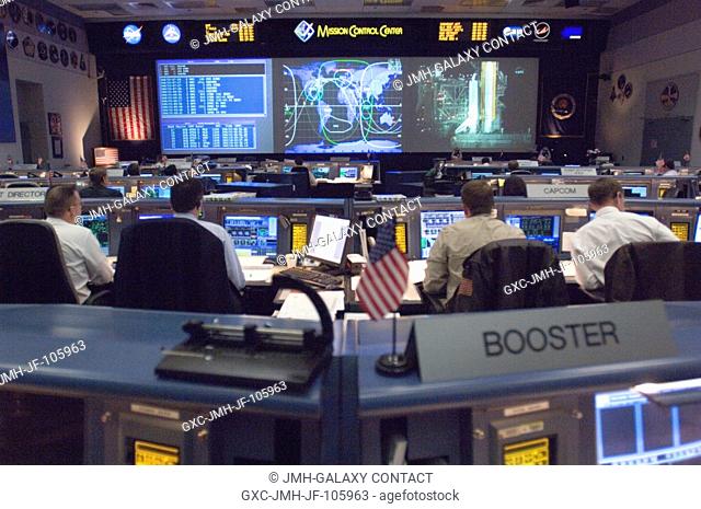 Overall view in the shuttle flight control room, from the point of view of the Booster console, on launch day for STS-116