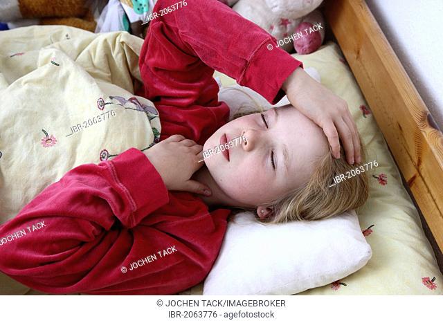 Girl, 10 years old, is ill in bed with a cold, flu, fever