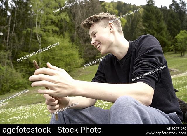 Young boy in countryside, taking a rest. Bad Tölz, Upper bavaria, Germany