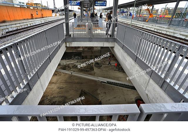 29 October 2019, Bavaria, Augsburg: The large construction site of the station tunnel at the main station can be seen under a platform
