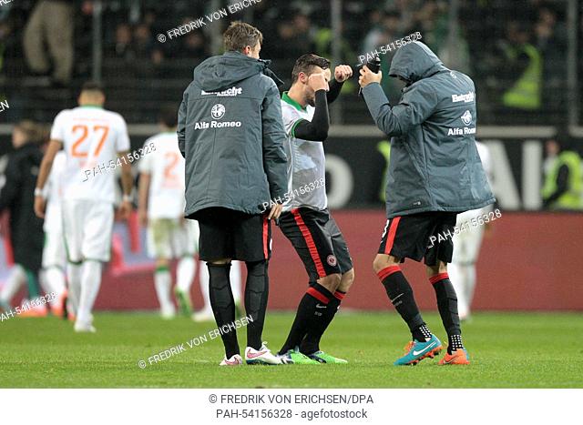 Frankfurt's Haris Seferovic (C) and Bamba Anderson perform a winner's dance after the final whistle in the Bundesliga soccer match between Eintracht Frankfurt...