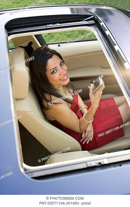High angle view of a young woman sitting in a car