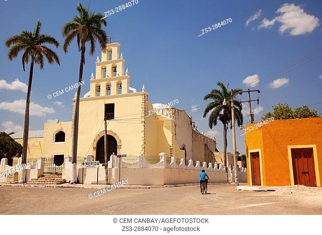 Cyclist in front of the church at the town center, Chumayel, Convent Route, Yucatan Province, Mexico, Central America