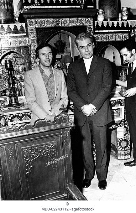 French actor Jean-Louis Trintignant posing with Italian actor Gian Maria Volonté in the Café de la Mosquée on the set of the film Plot. Paris, 1972