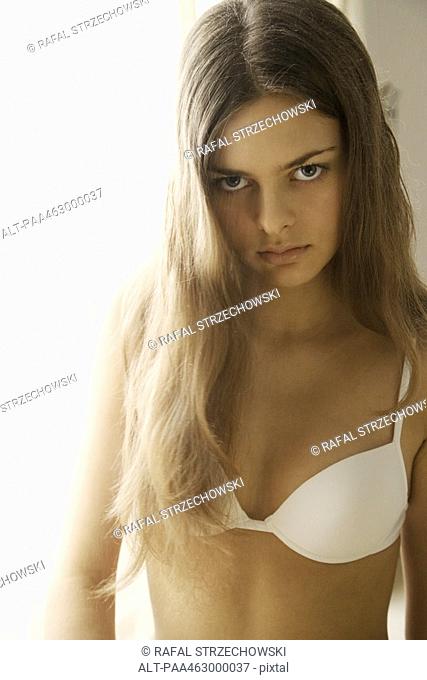 Young woman in bra, looking at camera