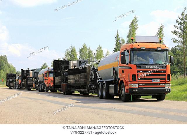 Kaarina, Finland - July 28, 2018: Roadworks asphalting machinery transport trucks parked on a freeway rest stop in summer in South of Finland