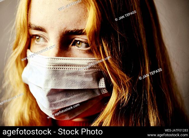 Close-up of teenage girl wearing protective face mask