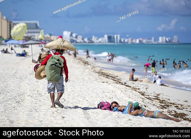 CANCUN, MEXICO - SEPTEMBER 29: A seller offers hats for tourists while they enjoy holidays after 5 months for coronavirus lockdown