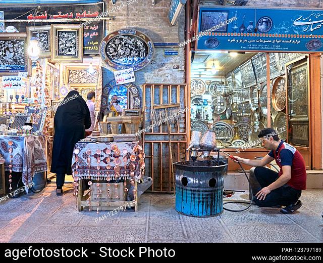 A coppersmith in the grand bazaar of the city of Isfahan in southern Iran, taken on April 26, 2017. The bazaar (Bazar-e Qeysariyeh or Bazar-e Bozorg) at Imam...