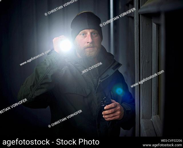 Watchman searching site with torchlight