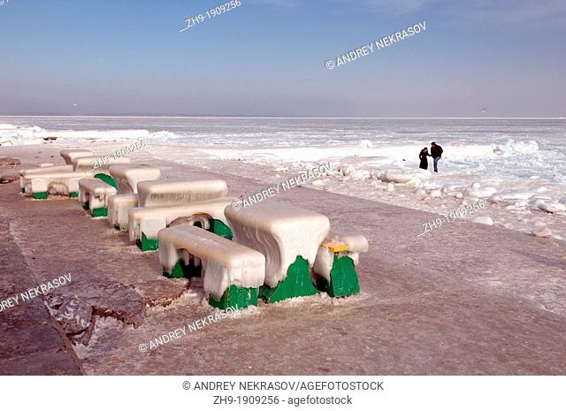 Icy cafe tables and benches on the beach of the frozen Black Sea, a rare phenomenon, last time it occured in 1977, Odessa, Ukraine, Eastern Europe