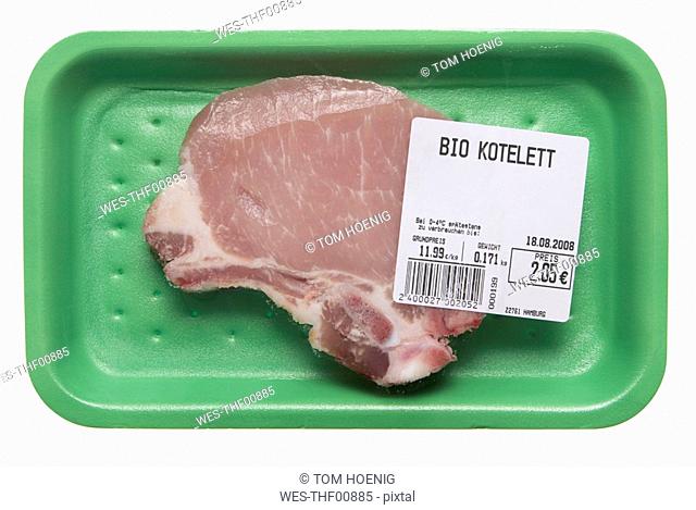 Raw pork chop in styrofoam plate, close-up