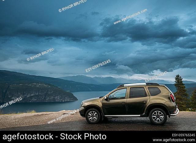 Utvik, Sogn Og Fjordane County, Norway. Car Suv Parked Near Scenic Route Road In Norwegian Mountain Lake Landscape. Innvikfjord Is A Sub-fjord Of Nordfjord In...