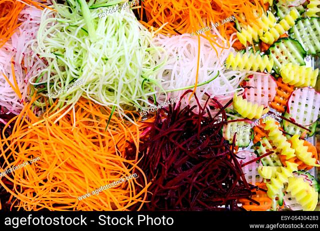 Different raw shredded vegetables and fruits as an example of a healthy diet