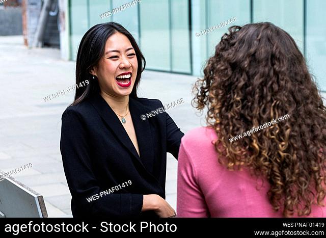 Happy woman looking at female friends