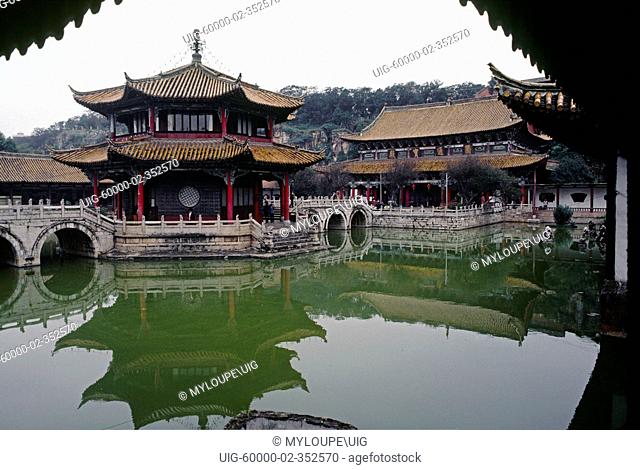 1000 year old Buddhist YUANTONG TEMPLE sits on the waters of CUIHU GREEN LAKE PARK in KUNMING - YUNNAN, CHINA