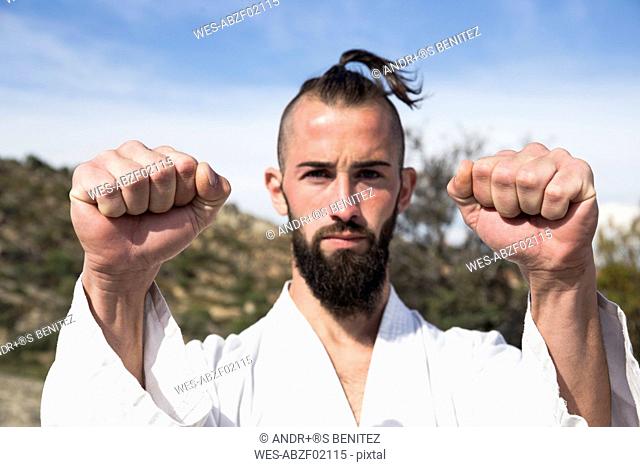 Portrait of man doing martial arts pose outdoors