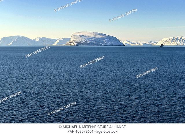 The coastlines from the islands Håja and Sørøya in the deep blue Norwegian Sea near by the town Hammerfest, 9 March 2017 | usage worldwide