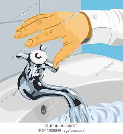 Hand turning off cold water tap on wash basin