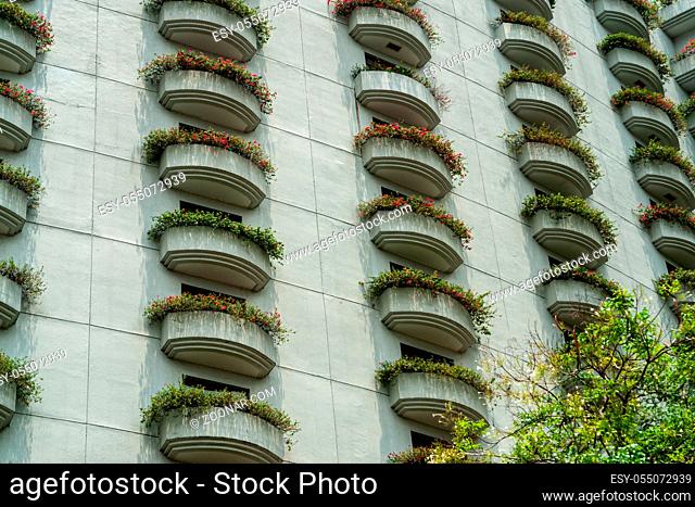Close-up photo of balconies covered with flowers. Details of balcony. Abstract on the subject of modern architecture, landscaping buildings, building exterior