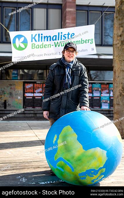 07 March 2021, Baden-Wuerttemberg, Freiburg: State parliament election candidate Alexander Grevel stands at a campaign stand of the Klimaliste on the square of...