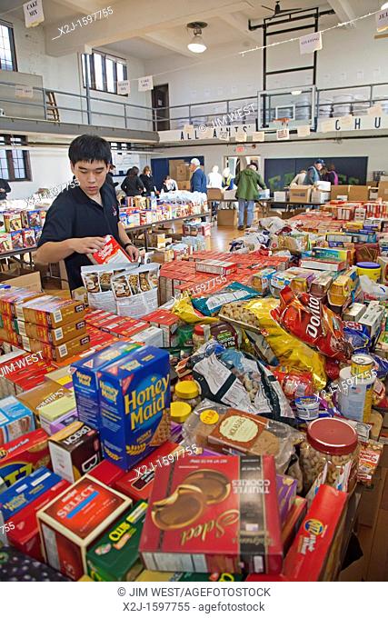 Pontiac, Michigan - Chris Xue, a senior at Orchard Lake St  Mary's, a Catholic boys school, sorts donated food which will be distributed to low-income families...