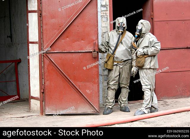 firefighters in chemical protection suit during the job