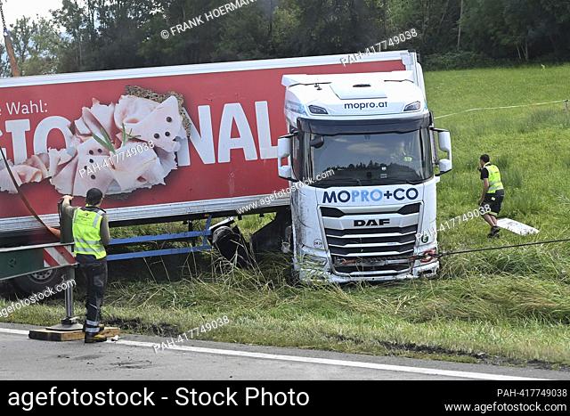 Recovery of a truck after an accident on the A8 motorway near Bernau am Chiemsee, a recovery crane with a cable winch pulls a truck that has left the roadway...
