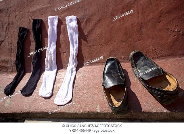 Shoes and socks of an undocumented Central American migrants traveling across Mexico to work in the United States dry in the sun at a shelter for migrants...