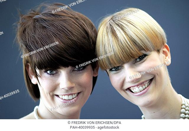 The models Ramona (R), Tim and Vanessa present the new haircut trends 'Aufgesetzter Bob' ('Bob put on top') (R), and 'Dr Bob' (L) at the fair 'Hair and Beauty...
