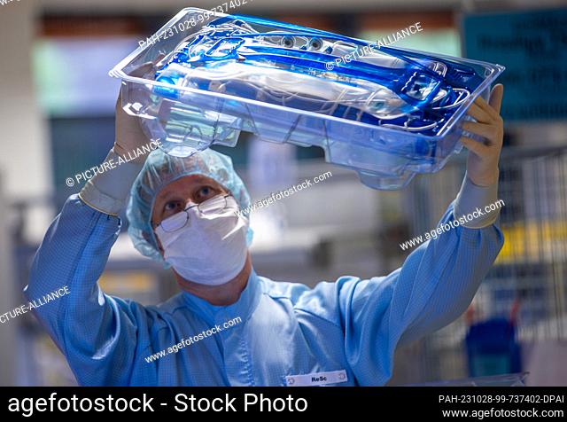 PRODUCTION - 24 October 2023, Mecklenburg-Western Pomerania, Teterow: Remo Schultz checks the packaging of a tube set in one of the clean rooms of Miltenyi...