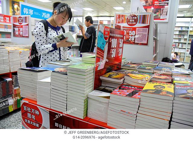China, Beijing, Wangfujing Xinhua Bookstore, shopping, inside, sale, books, Asian, woman, browsing, Chinese characters hànzì pinyin,
