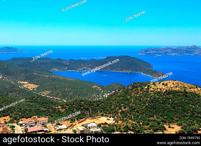 KAS, ANTALYA - JULY 19, 2015 : Seascape of Kas, touristic small town of Antalya, surrounded with high mountains with trees