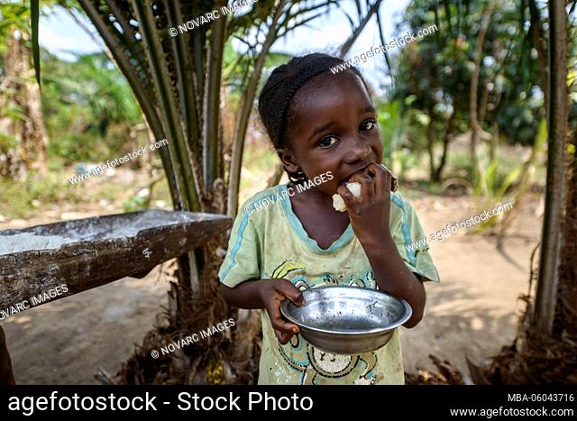 Girl eats cassava, Democratic Republic of the Congo, Africa