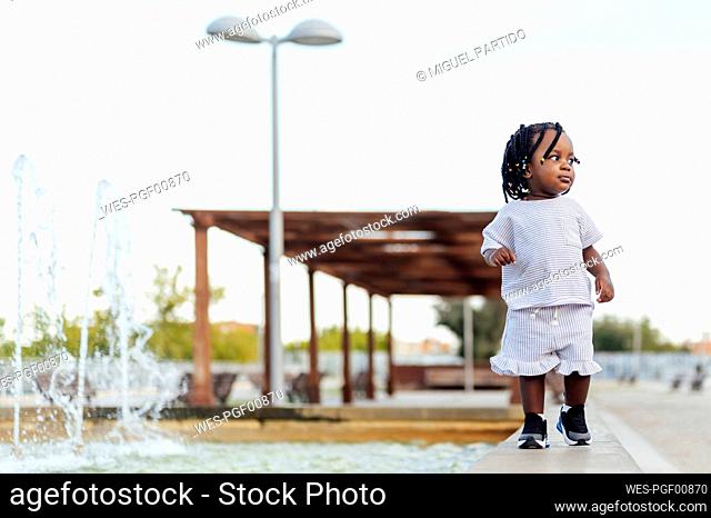 Girl walking by fountain