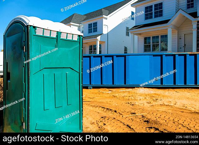 Portable bio toilet cabins at the construction on removal of debris construction waste building demolition with rock and concrete rubble