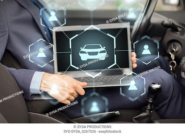 businessman with laptop and car sharing icons