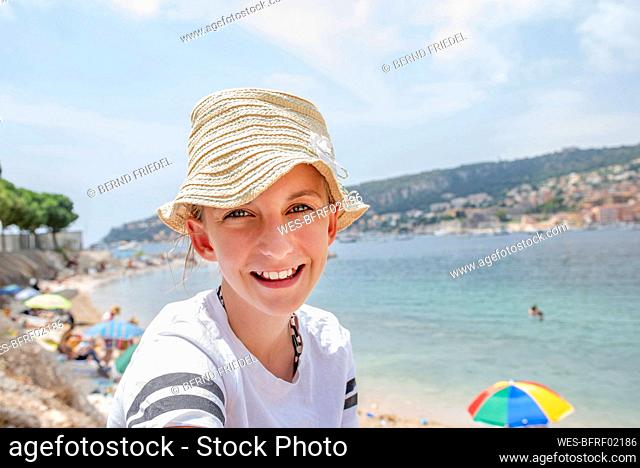 Girl with straw hat at the sea, Cote d'Azur, France