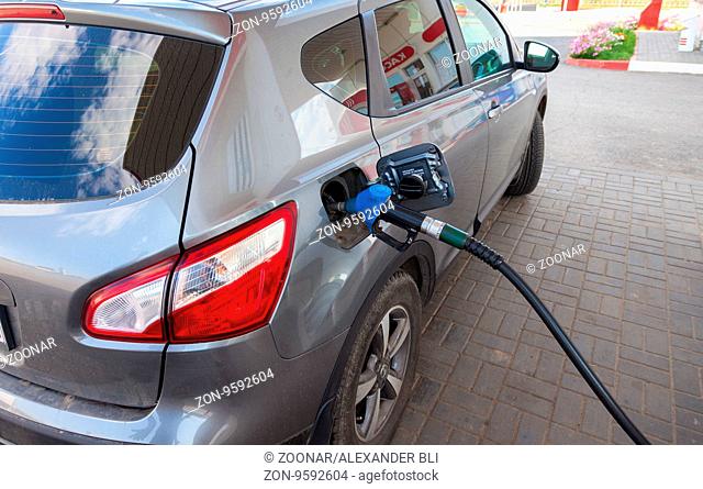 TVER REGION, RUSSIA - JUNE 26, 2016: Pumping gasoline fuel in passenger car at gas station