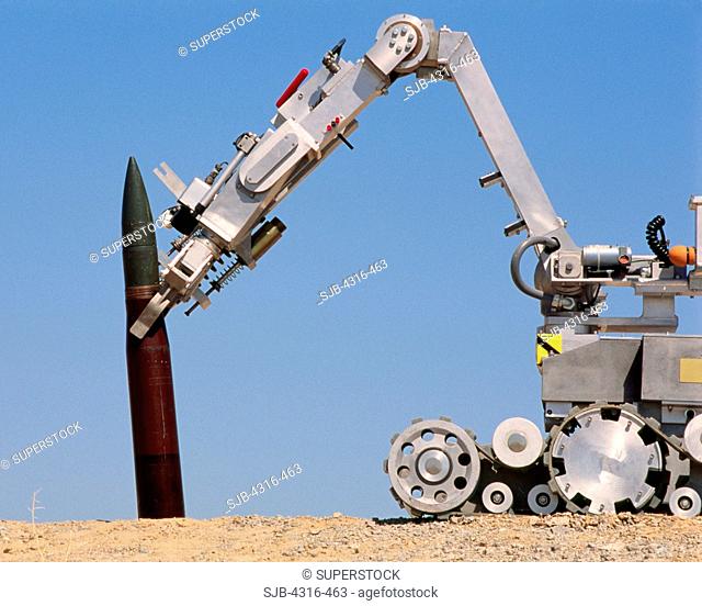 An Explosive Ordnance Disposal Robot Grips a 155mm High Explosive Artillery Round