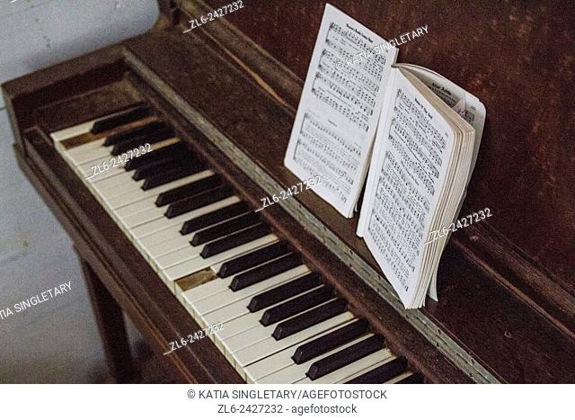 Old piano with missing pieces and keynotes in an old church in Cades Cove, Great Smoky Mountains, Tennessee, a vacation destination
