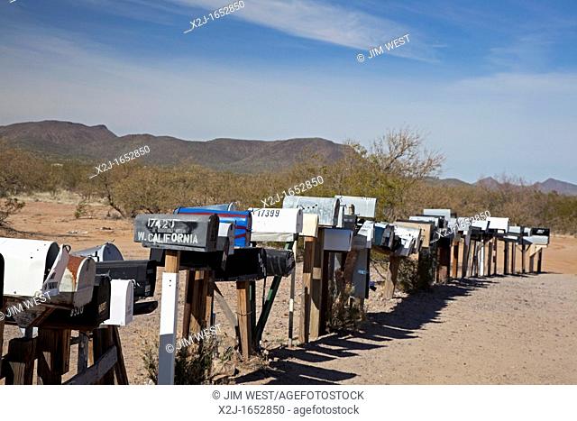 Three Pointes, Arizona - A long row of mailboxes are lined up along a dirt road in the desert west of Tucson