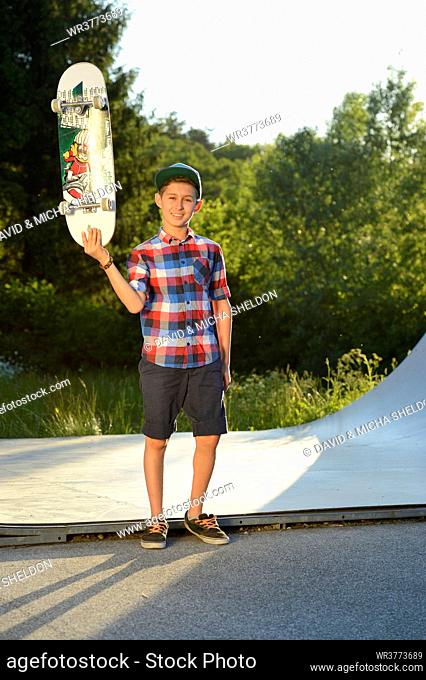 Boy with skateboard in a skatepark