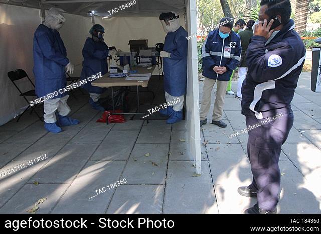 MEXICO CITY, MEXICO - DECEMBER 17: A Specialist weras Personal Protective Equipment (PPE) while makes a swab test a person to detect SARS Cov -2 who causes the...