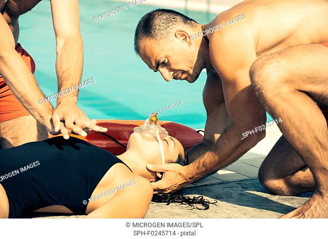 Two lifeguards in training, doing CPR. Toned image