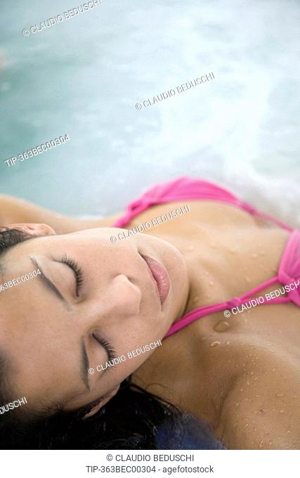 Woman relaxing in a thermal pool