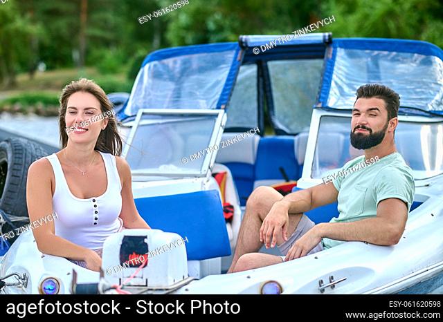 Boat trip. A happy couple on a boat looking peaceful and enjoyed