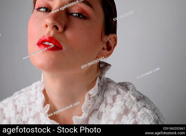 Beautiful young model with red lips wearing white dress. Isolated. High quality photo
